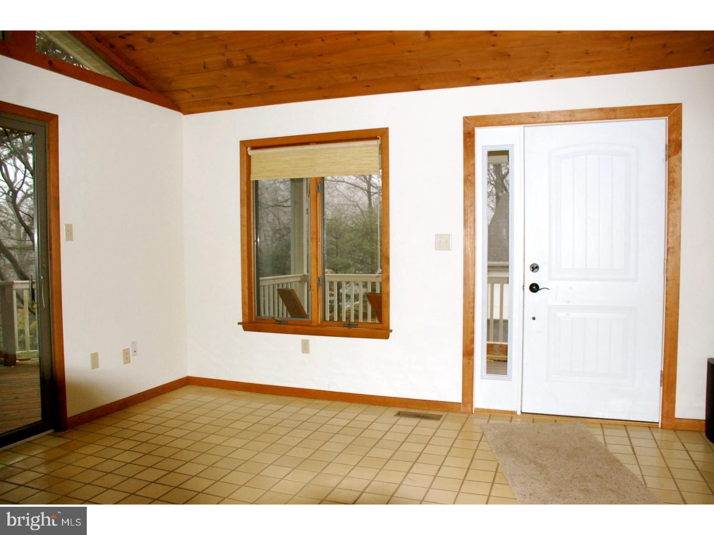 163 Mail Rte Road Sinking Spring, PA 19608 - Photo 10 of 25 a view of an empty room with wooden floor and a window