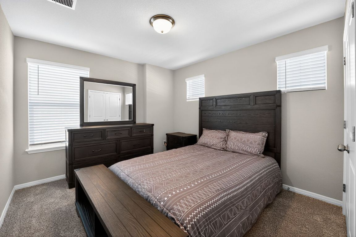 17801 Prairie Land Way Manor, TX 78653 - Photo 25 of 31 a bedroom with a bed and a dresser