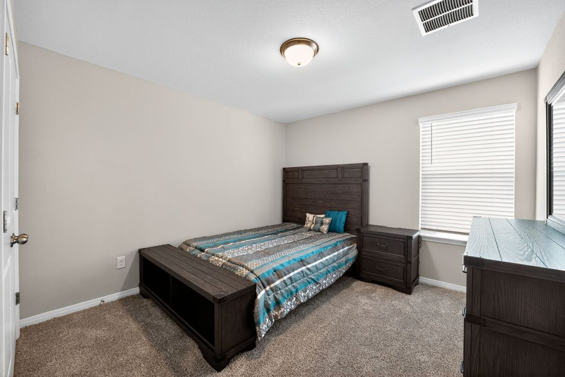 17801 Prairie Land Way Manor, TX 78653 - Photo 26 of 31 a bedroom with a bed and a window