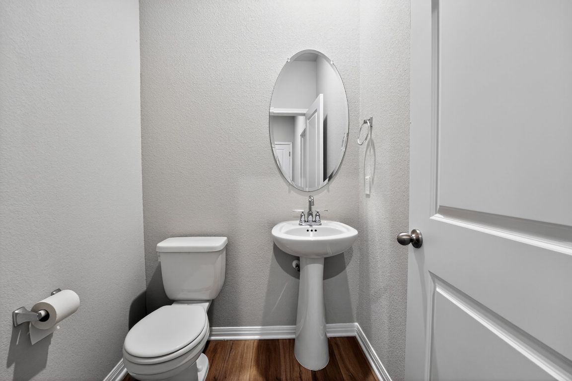 17801 Prairie Land Way Manor, TX 78653 - Photo 27 of 31 a bathroom with a toilet sink and mirror