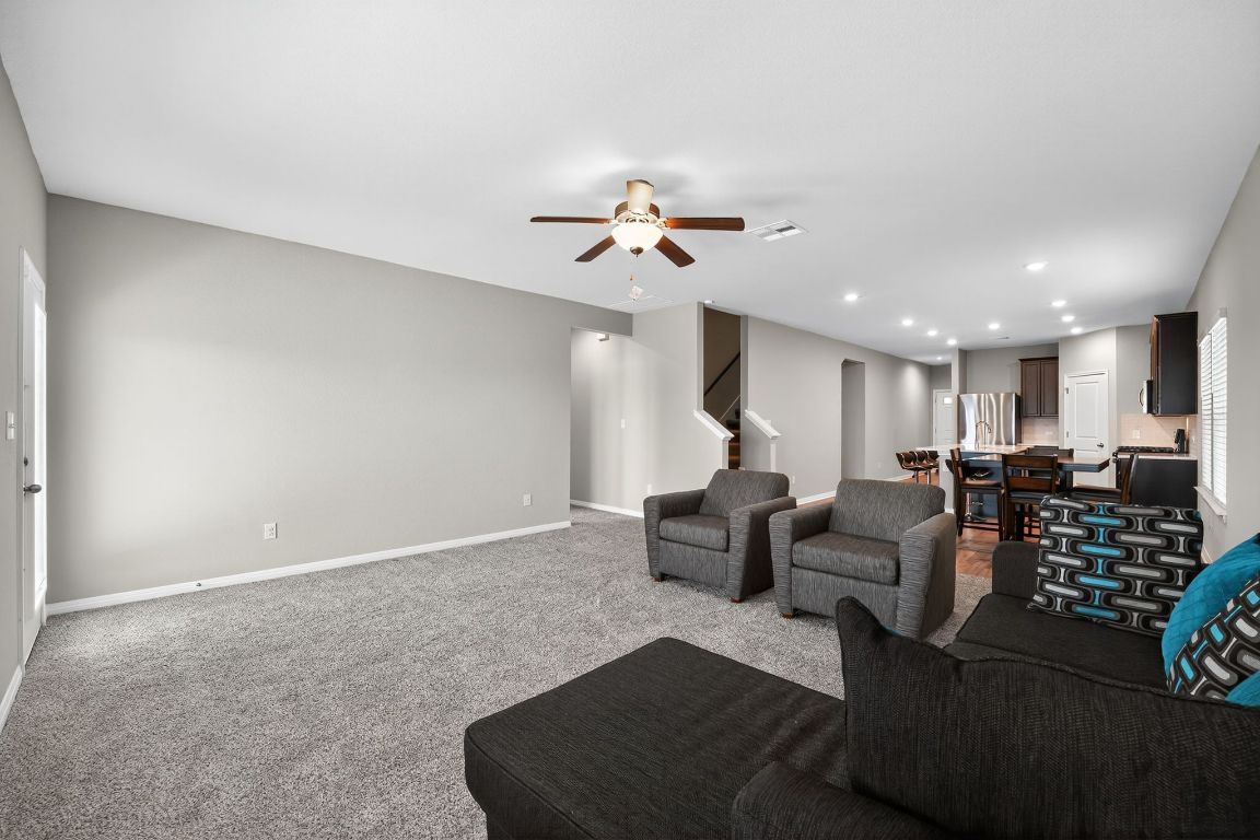 17801 Prairie Land Way Manor, TX 78653 - Photo 4 of 31 a living room with furniture and a chandelier