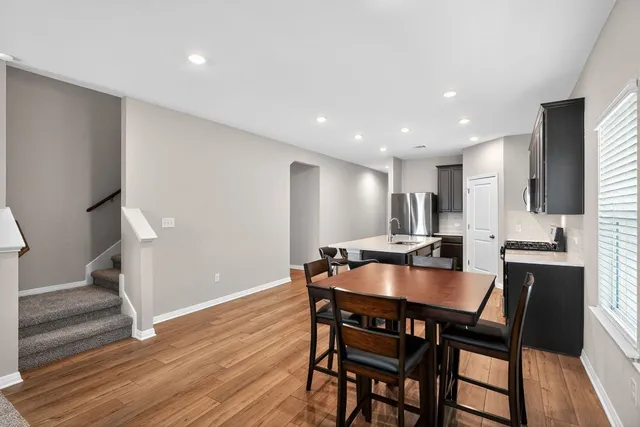 a dining room with furniture and wooden floor