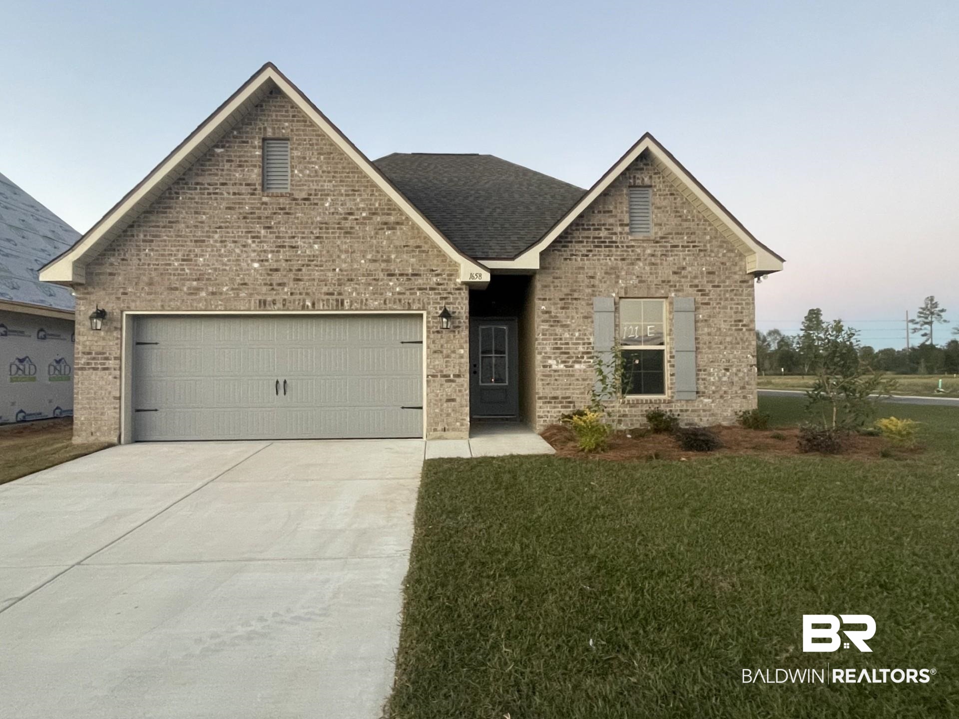 1658 Fenton Circle Foley, AL 36535 - Photo 1 of 3 View of front of property with a front lawn and a garage