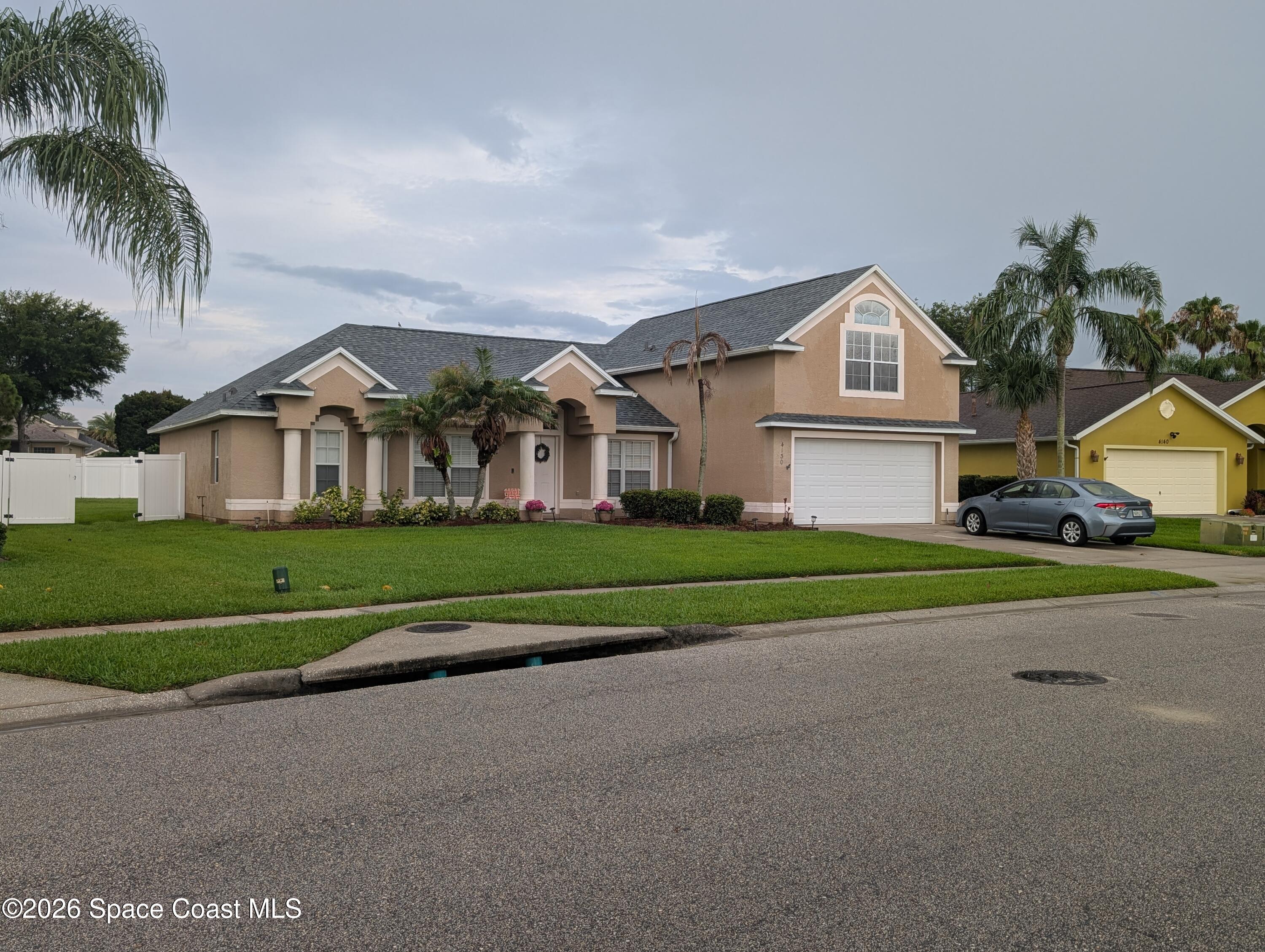 4130 Orion Way Rockledge, FL 32955 - Photo 1 of 14 a front view of house with yard and green space
