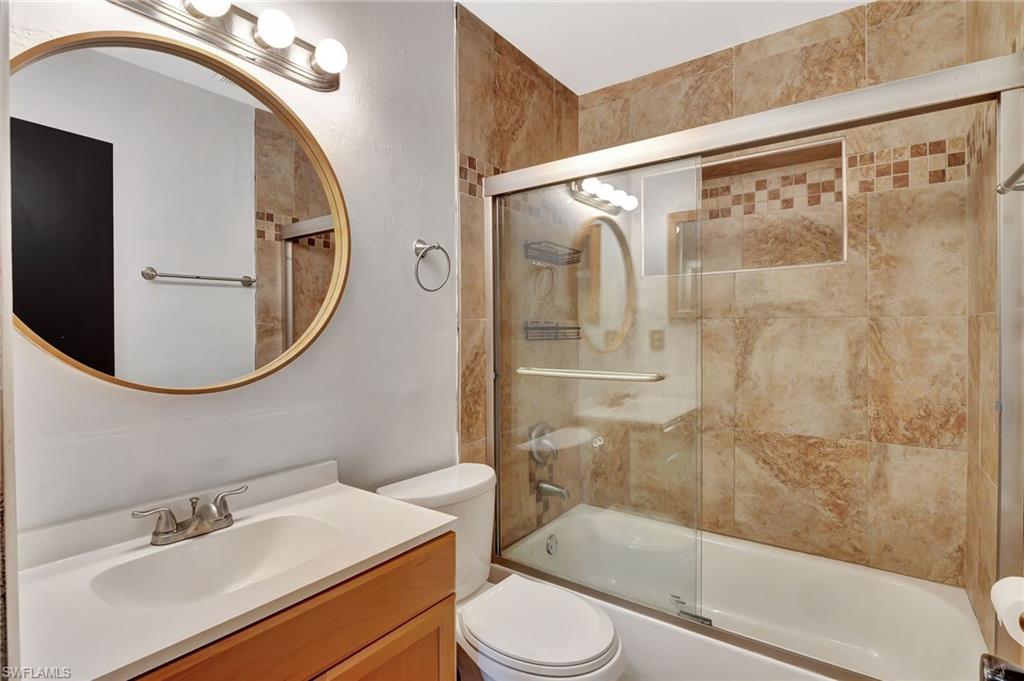14 Illinois Road Lehigh Acres, FL 33936 - Photo 23 of 31 a bathroom with a sink mirror toilet and shower