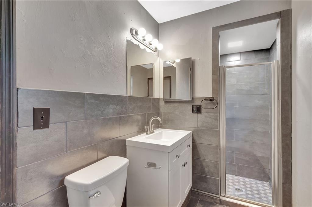 14 Illinois Road Lehigh Acres, FL 33936 - Photo 27 of 31 a bathroom with a toilet sink and mirror