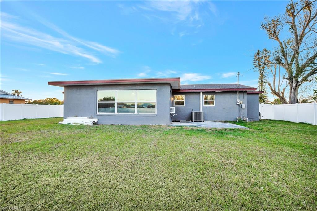 14 Illinois Road Lehigh Acres, FL 33936 - Photo 30 of 31 front view of a house with a yard