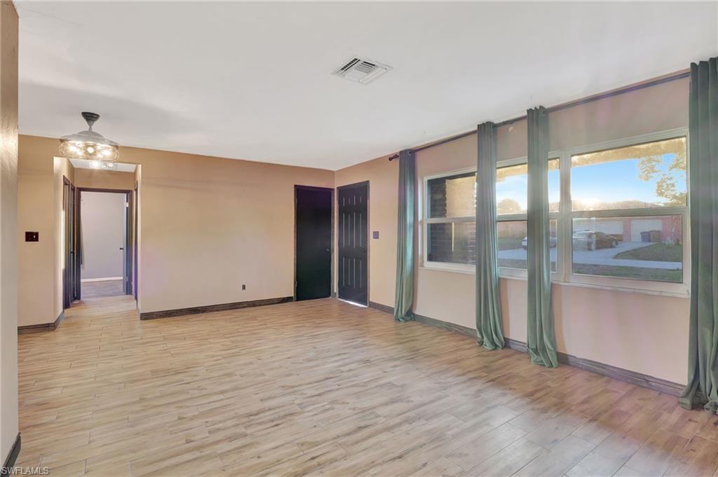 14 Illinois Road Lehigh Acres, FL 33936 - Photo 4 of 31 a view of an empty room with glass door
