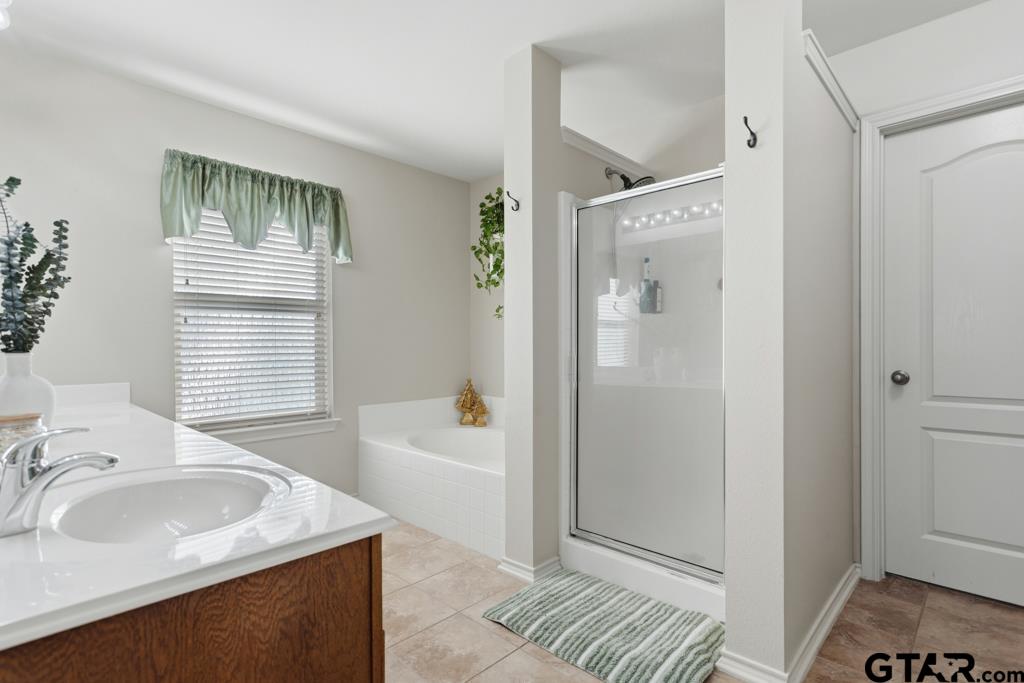5821 Thompson Place Tyler, TX 75707 - Photo 19 of 34 a bathroom with a sink and a bathtub