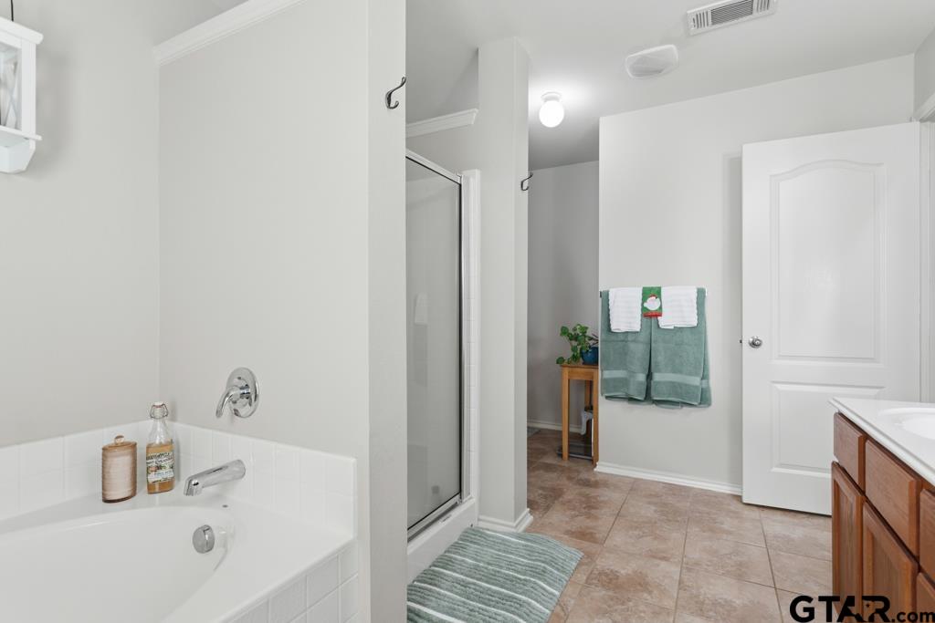 5821 Thompson Place Tyler, TX 75707 - Photo 22 of 34 a bathroom with a sink and shower