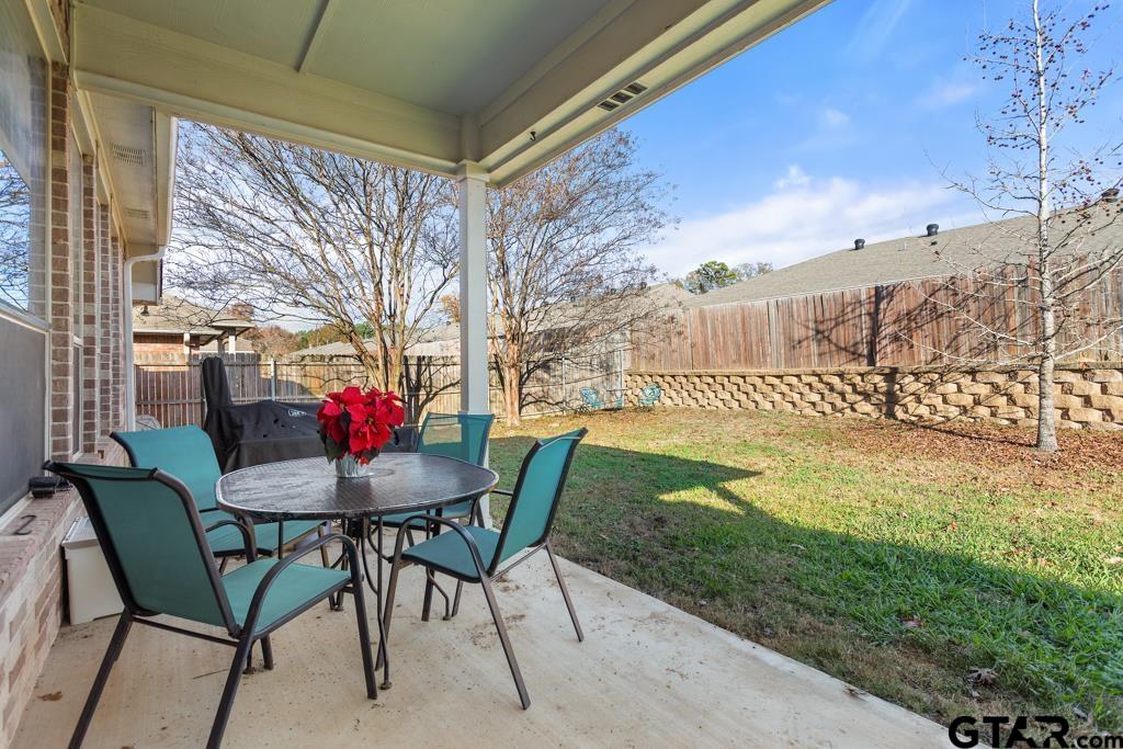 5821 Thompson Place Tyler, TX 75707 - Photo 30 of 34 a view of a patio with table and chairs and potted plants