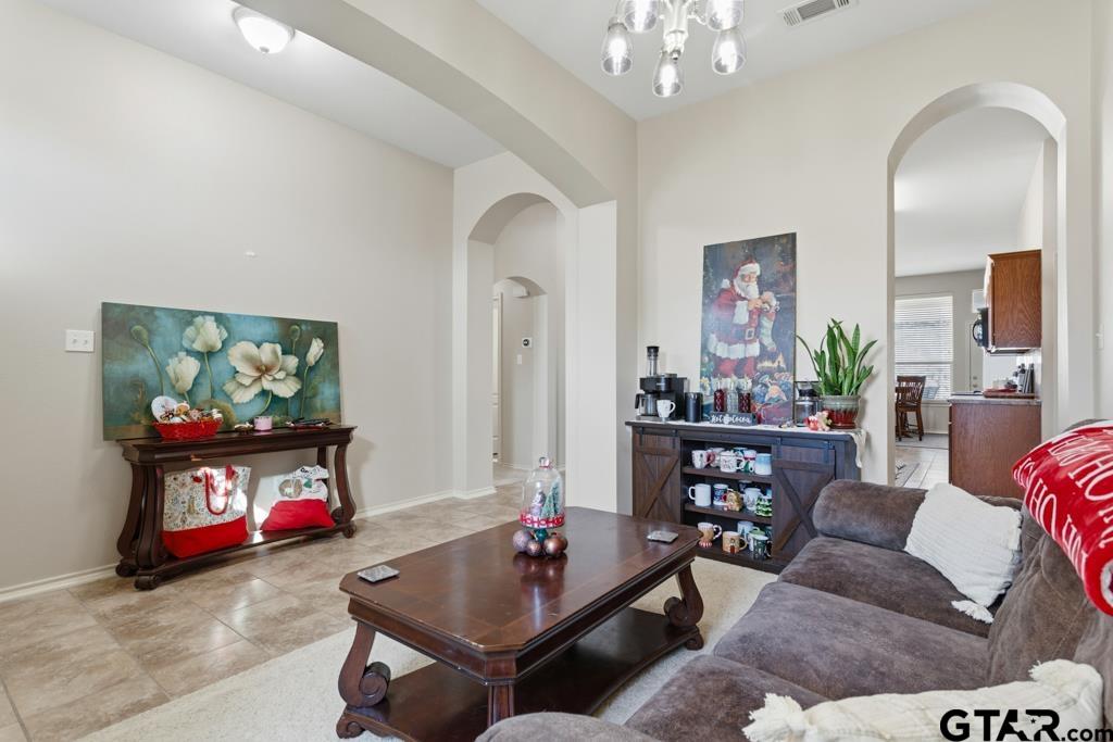 5821 Thompson Place Tyler, TX 75707 - Photo 6 of 34 a living room with furniture and a flat screen tv