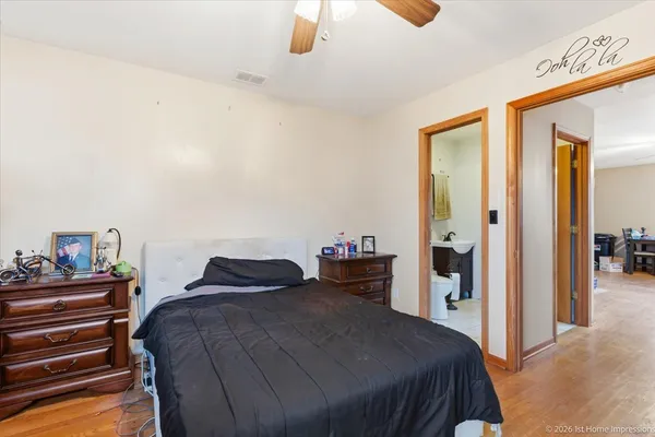 a bedroom with a bed and a chandelier