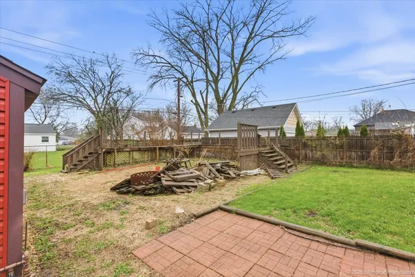 a view of a backyard with table and chairs and a fire pit