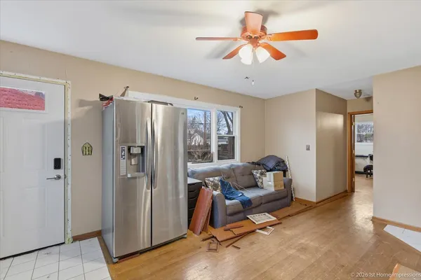 a living room with furniture a ceiling fan and a window