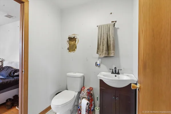 a bathroom with a sink and mirror with toilet