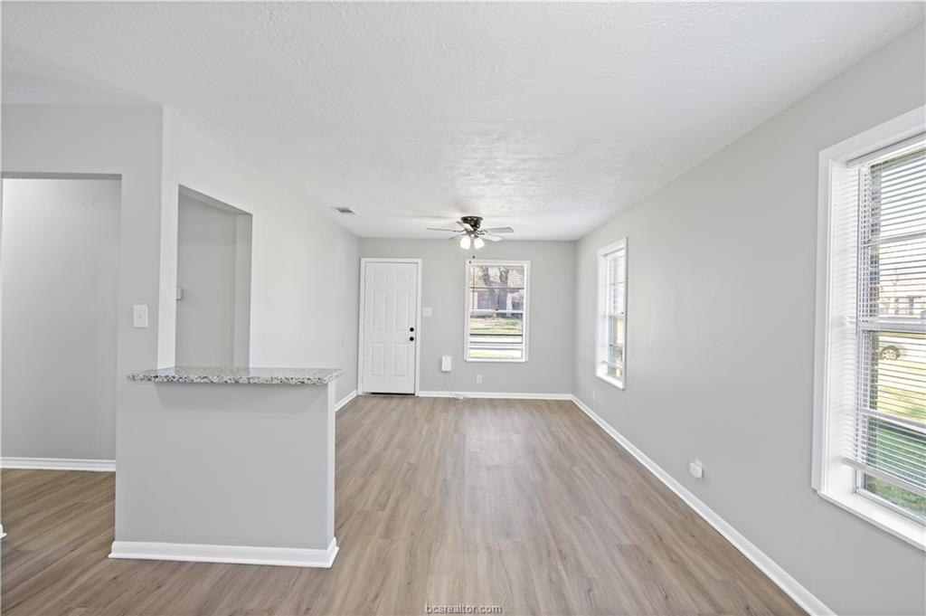 1907 Orman Street Bryan, TX 77801 - Photo 6 of 20 an empty room with wooden floor and windows