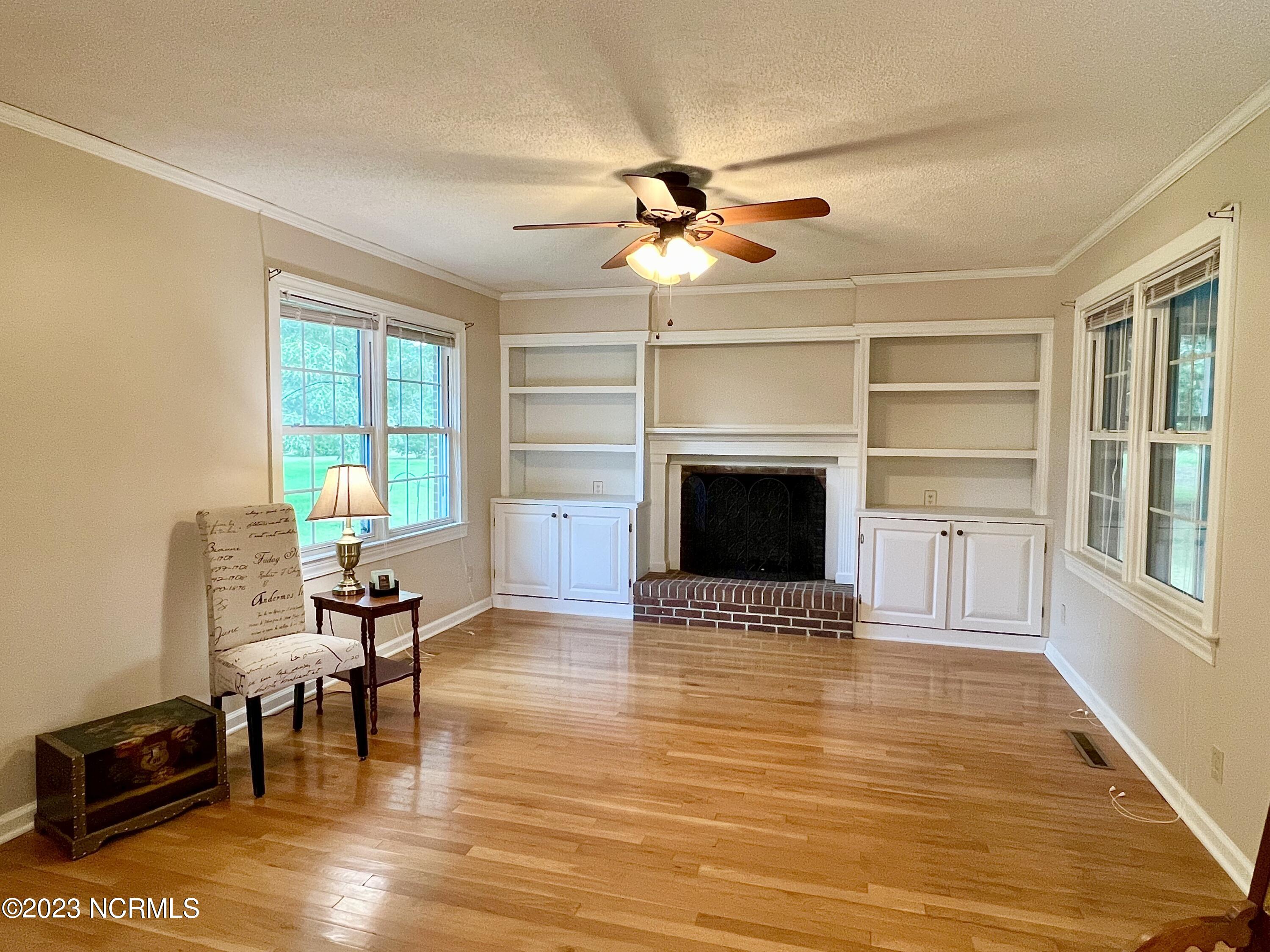 101 Manor Road Edenton, NC 27932 - Photo 2 of 16 Living room with wood flooring, fireplace and built-ins