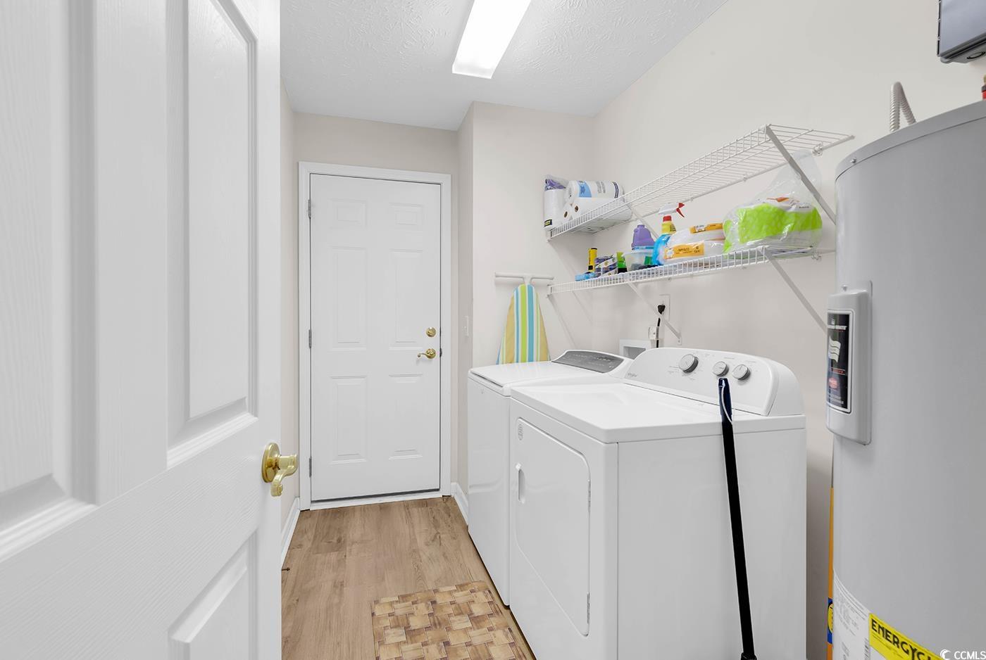 653 Pamlico Court Myrtle Beach, SC 29588 - Photo 22 of 39 Laundry area with water heater, washer and clothes dryer.