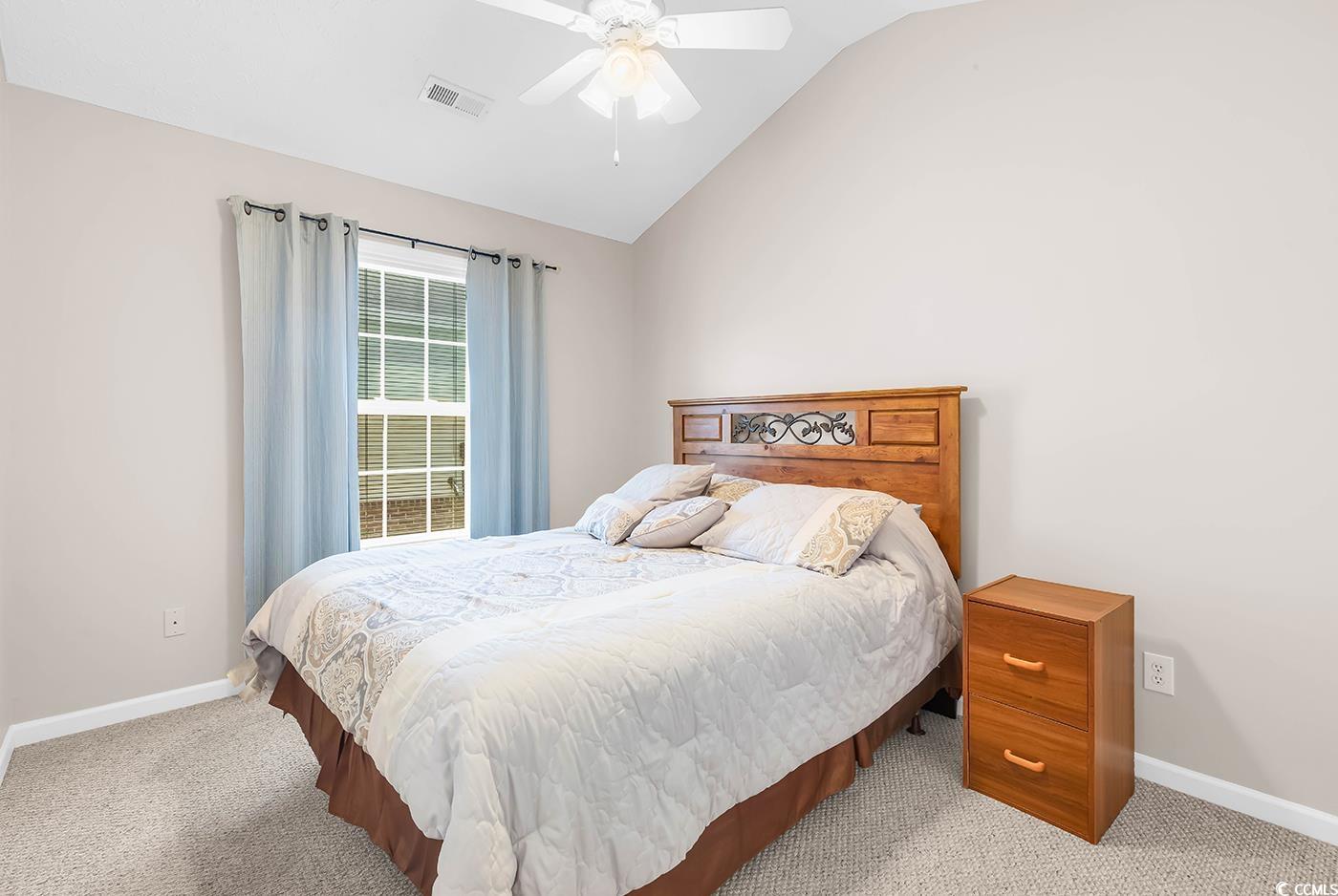 653 Pamlico Court Myrtle Beach, SC 29588 - Photo 25 of 39 Carpeted bedroom featuring vaulted ceiling and a ceiling fan