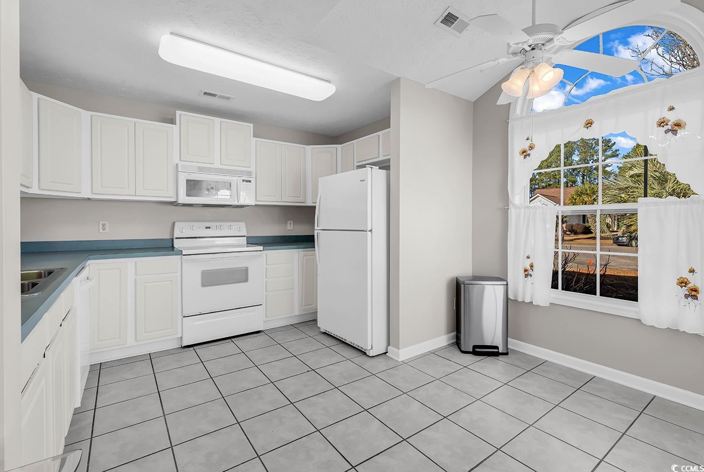653 Pamlico Court Myrtle Beach, SC 29588 - Photo 6 of 39 Kitchen featuring white appliances, white cabinetry, ceiling fan.