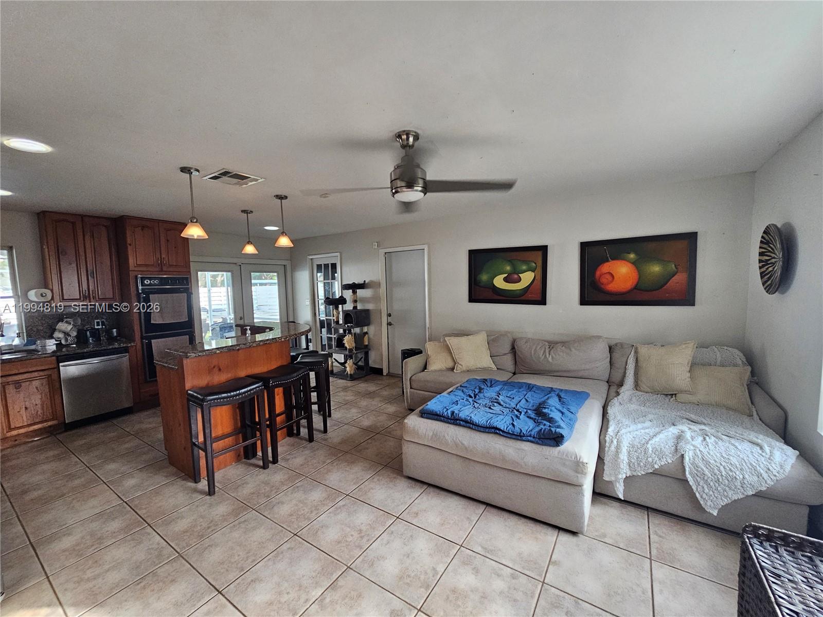 14461 Southwest 152nd Court Miami, FL 33196 - Photo 3 of 14 a living room with furniture and a chandelier