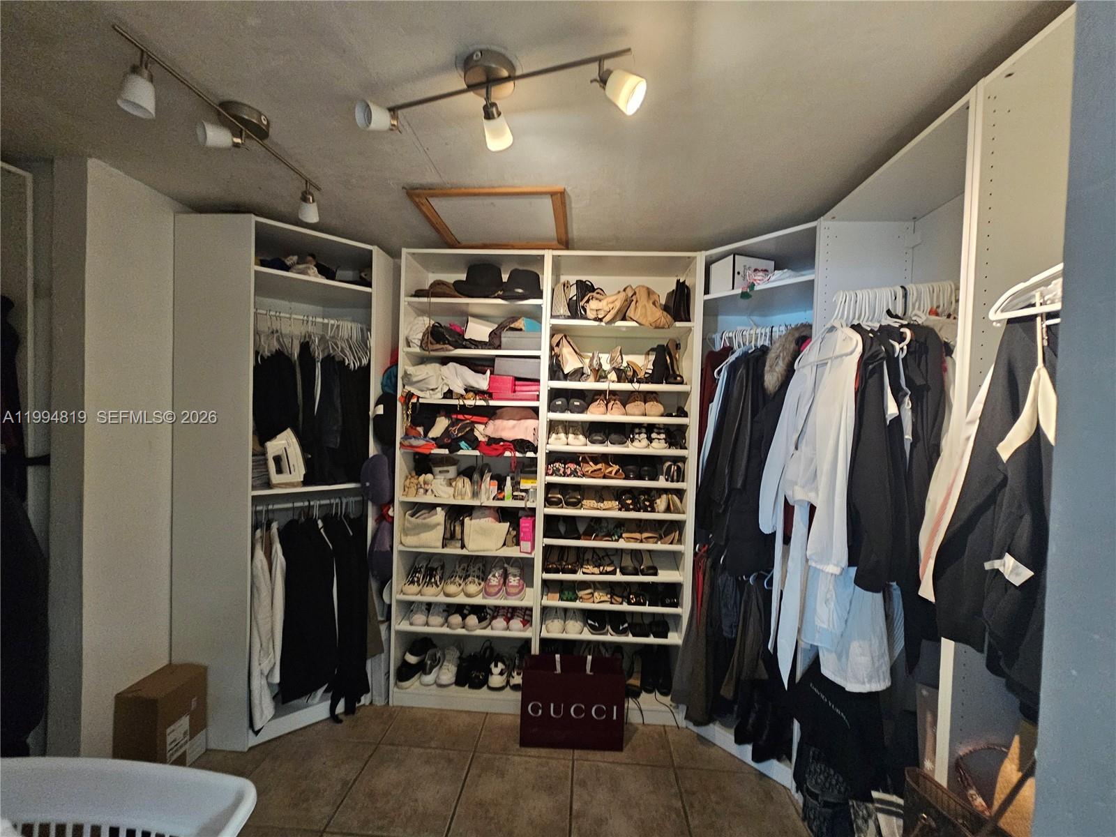 14461 Southwest 152nd Court Miami, FL 33196 - Photo 5 of 14 a view of walk in closet with clothes and shoes