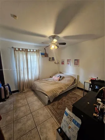 a bedroom with a bed and a view of bathroom
