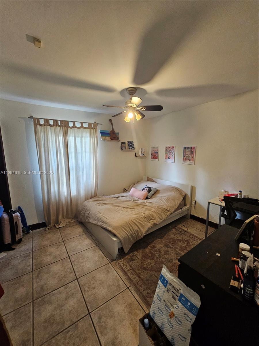 14461 Southwest 152nd Court Miami, FL 33196 - Photo 7 of 14 a bedroom with a bed and a view of bathroom