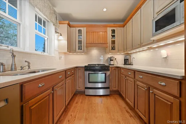 a kitchen with stainless steel appliances granite countertop cabinets and a stove top oven