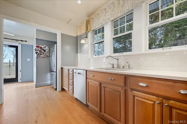 a view of a kitchen with a sink and a refrigerator