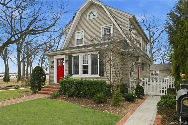 a view of a brick house with a large windows and a yard