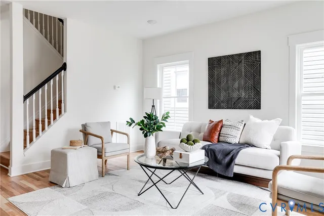 a living room with furniture and wooden floor