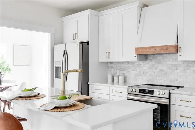 a kitchen with stainless steel appliances kitchen island wooden cabinets and a counter top space