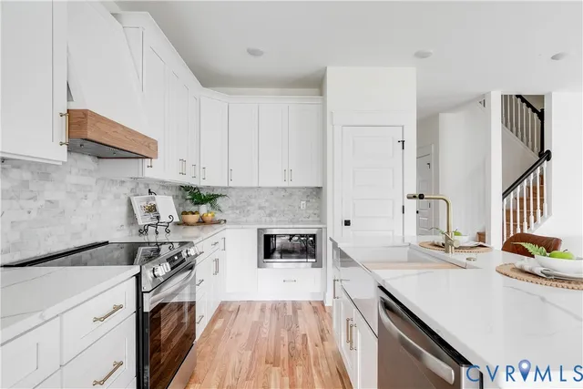 a kitchen with granite countertop a sink stove and cabinets