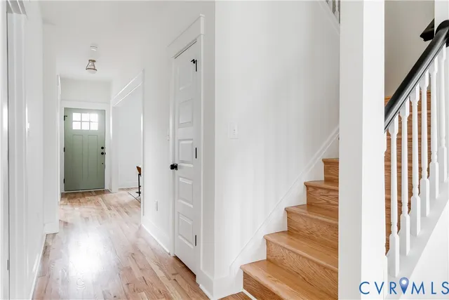a view of a hallway with wooden floor and entryway