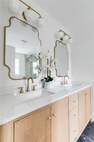 a bathroom with a double vanity sink and a mirror