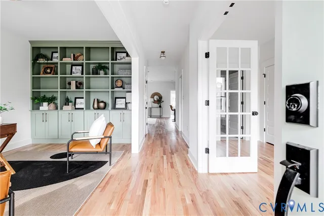a living room with furniture wooden floor and a book shelf