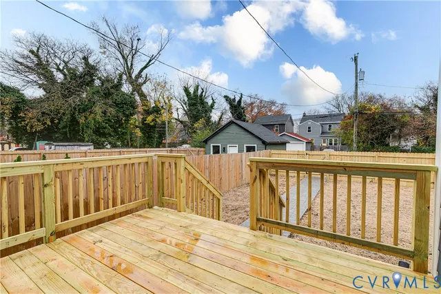 a view of a balcony with wooden floor and fence