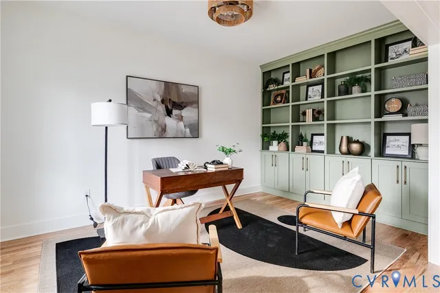 a living room with furniture and a book shelf
