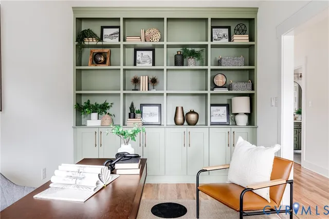 a living room with furniture and a book shelf