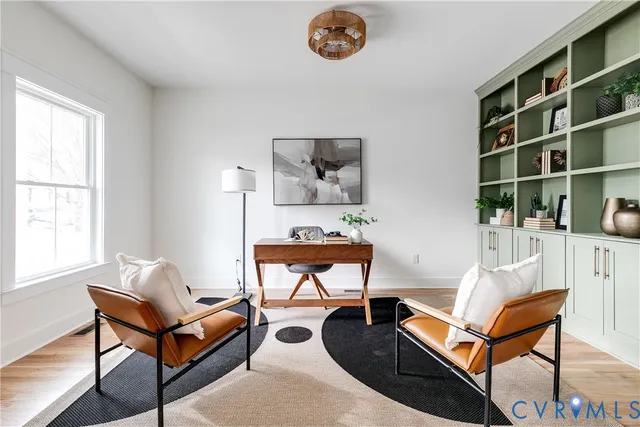 a living room with furniture a rug and a window