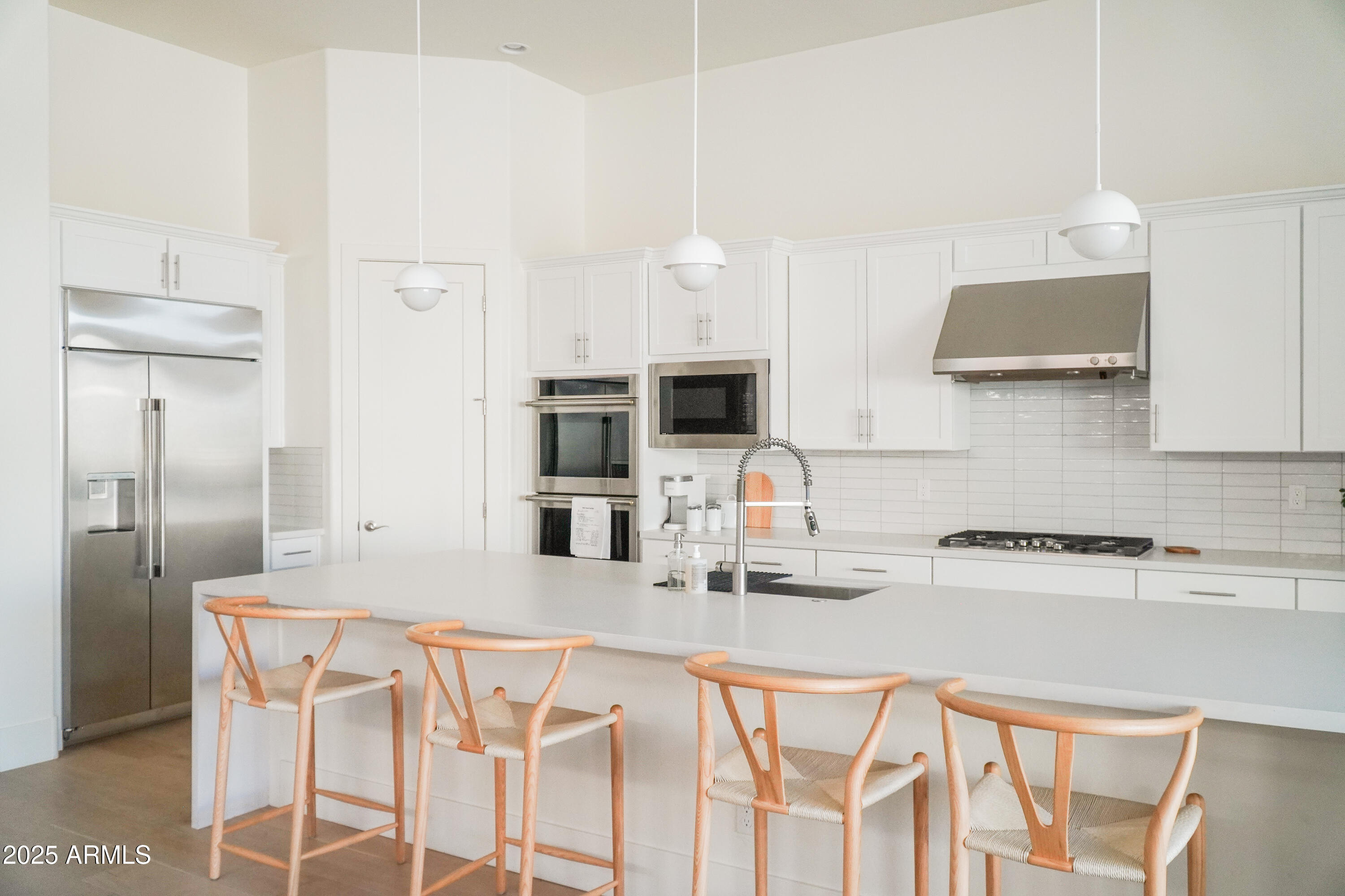 38500 North School House Road, Unit 40 Cave Creek, AZ 85331 - Photo 1 of 15 a kitchen with stainless steel appliances granite countertop a kitchen island a stove a sink a refrigerator with white cabinets and wooden floor