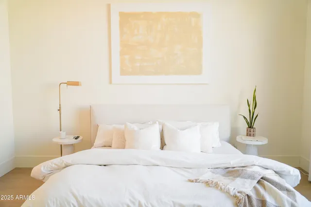 a bedroom with a bed and a window