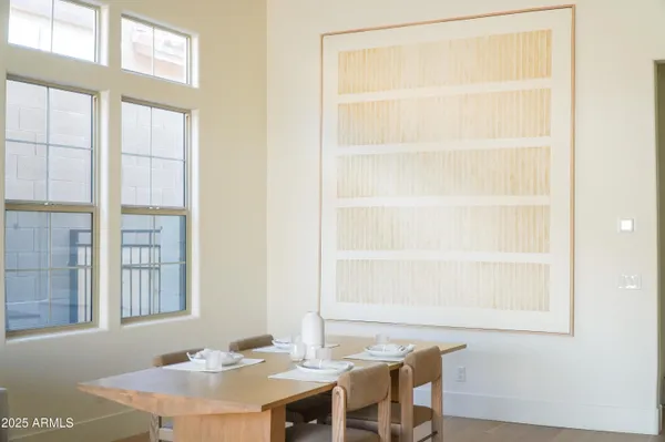 a dining room with a table and chairs