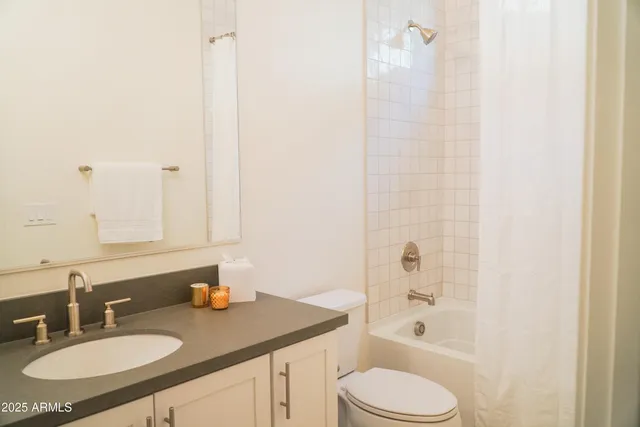 a bathroom with a granite countertop sink toilet a mirror and shower