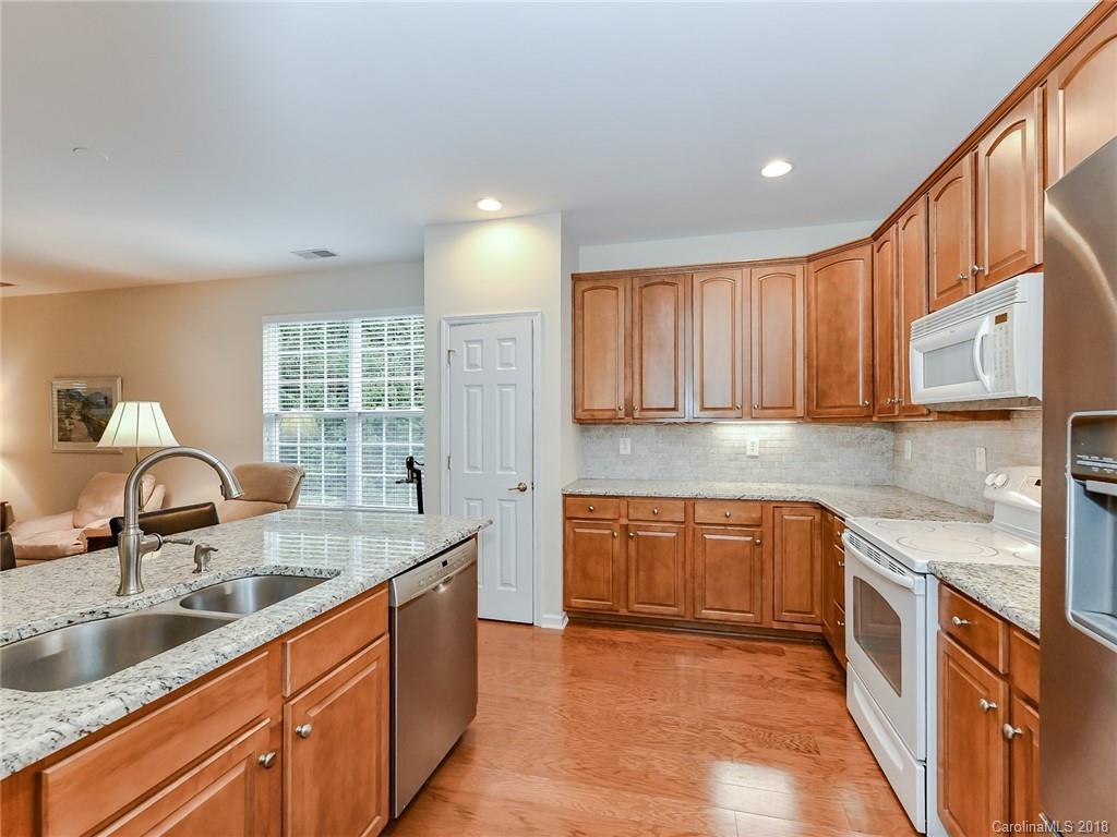 389 Garnet Court Fort Mill, SC 29708 - Photo 14 of 29 a kitchen with stainless steel appliances granite countertop a sink stove and cabinets