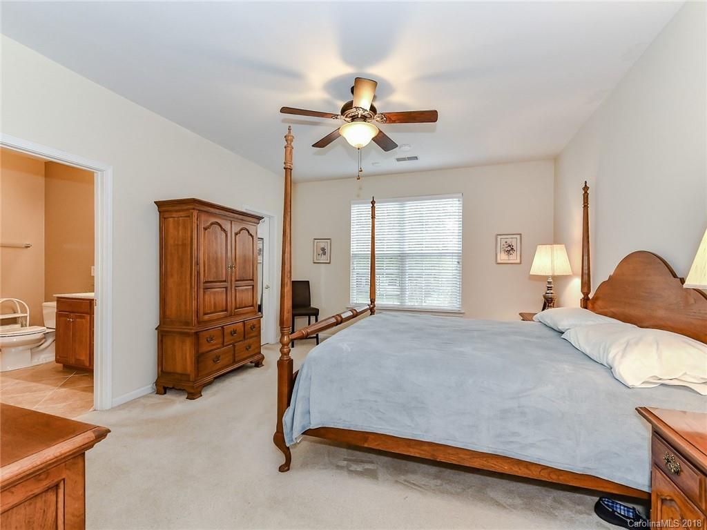 389 Garnet Court Fort Mill, SC 29708 - Photo 17 of 29 a bedroom with a bed and a chandelier
