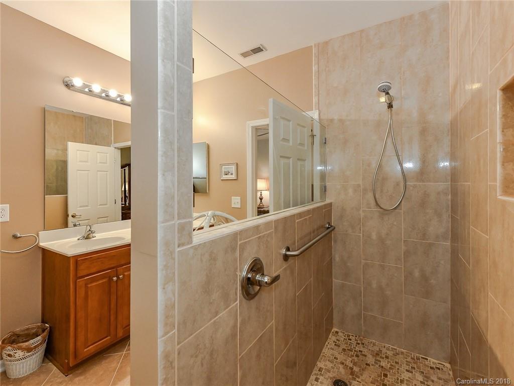 389 Garnet Court Fort Mill, SC 29708 - Photo 19 of 29 a bathroom with a granite countertop shower a mirror and a sink