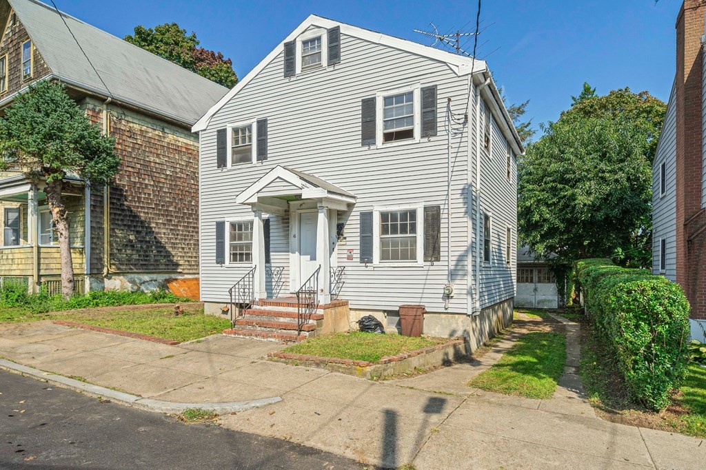 a front view of a house with garden